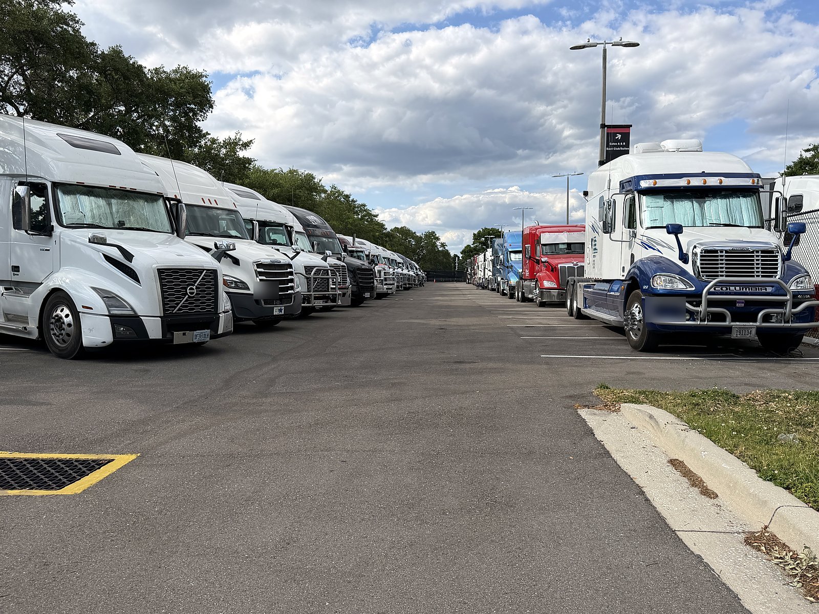 Rows of tractors and trailers in a lot